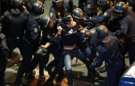 spanish-riot-police-surround-protester