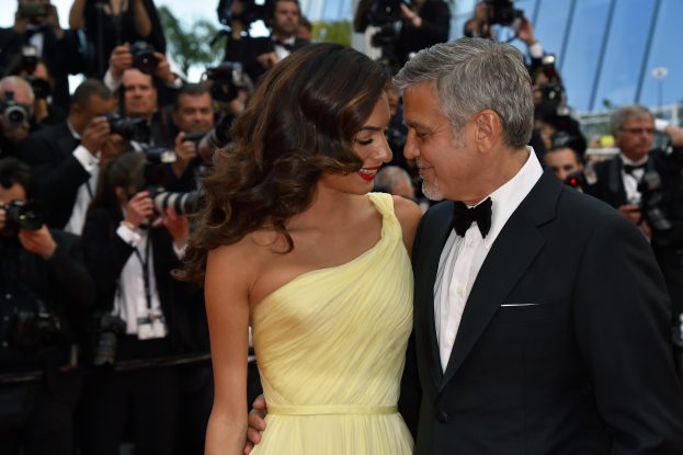 US actor George Clooney (R), and his wife British-Lebanese lawyer Amal Clooney pose on May 12, 2016 as they arrive for the screening of the film "Money Monster" at the 69th Cannes Film Festival in Cannes, southern France. / AFP PHOTO / LOIC VENANCE