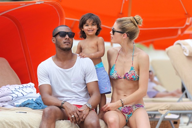 Victoria's Secret angel Doutzen Kroes with husband Sunnery James and their two-year-old son Phyllon at the beach in Miami Beach, FL. Doutzen wore a floral print bikini and Ray Ban Wayfarer sunglasses as she attempted to play football with her son. Pictured: Sunnery James, Phyllon Joy James and Doutzen KroesRef: SPL516244  250313  Picture by: Pichichi / Splash NewsSplash News and PicturesLos Angeles:310-821-2666New York:	212-619-2666London:	870-934-2666photodesk@splashnews.com